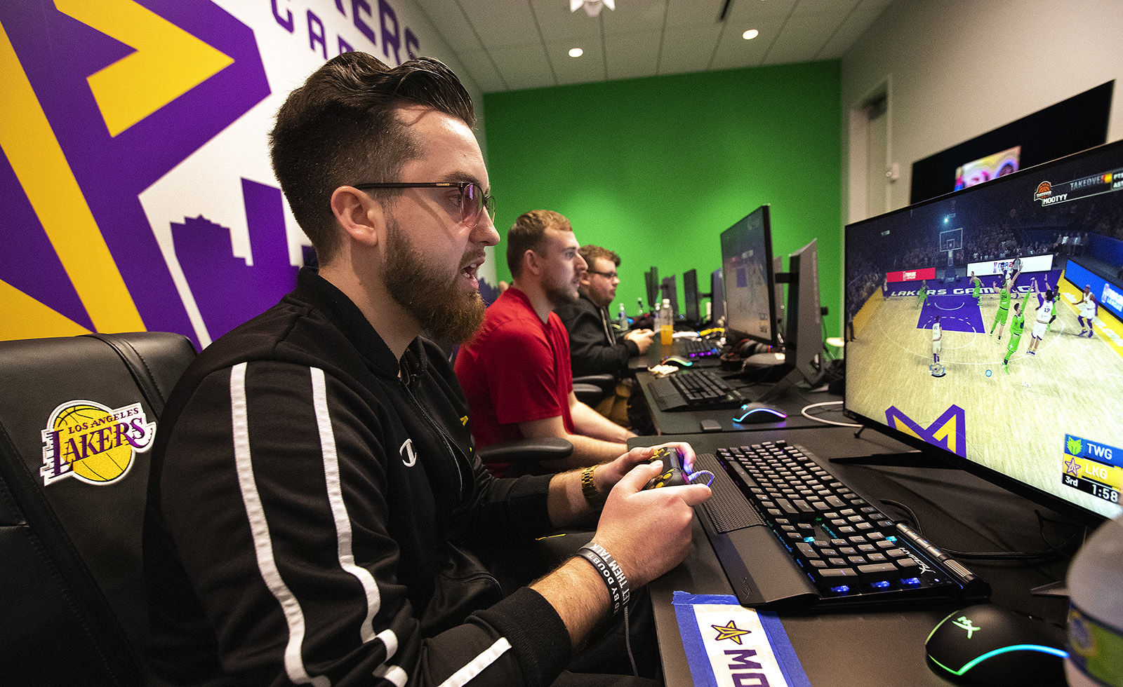Left to right: "Mooty" Mitchell Franklin, 25, "Detoxys" Christopher Doyle, 23, and "Vert" Jordan Gates, 20, members of the Los Angeles Lakers NBA 2K league, scrimmage against the Minnesota Timberwolves 2K team, while inside the gaming room at the Lakers practice facility in El Segundo, California.